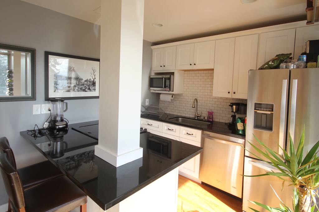 Kitchen with dishwasher and coffee maker.