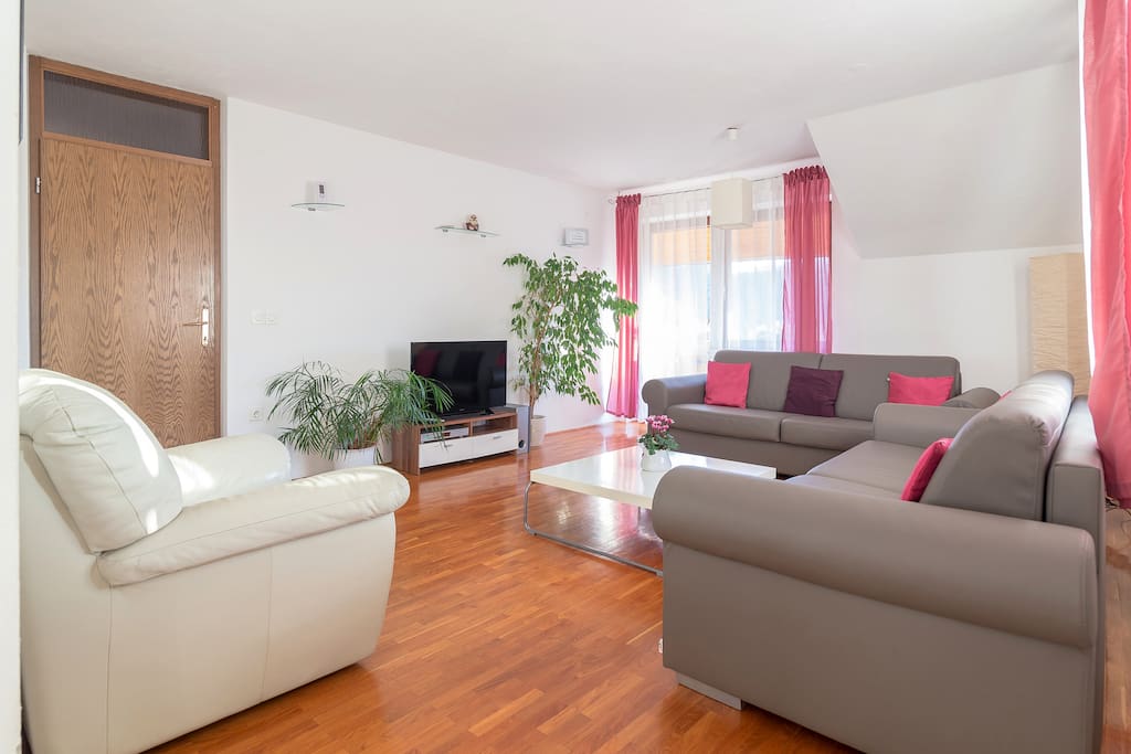 A large living room with 2 high quality sofas, an armchair and a large Sony Bravia TV with more than 180 international channels (including several very popular channels in English and German language and some in Italian, French and other languages).