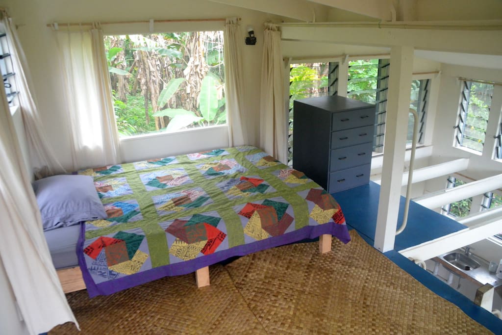 A single bed is on the first floor, near the kitchen area.