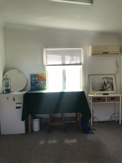 A fridge and desk for your convenience.