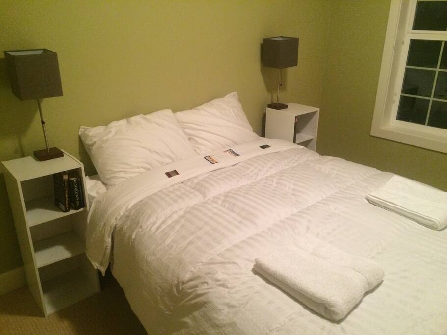 The bedroom includes a queen mattress with a 540 thread count six piece sateen sheet set, and a 500 thread count European Down Comforter.