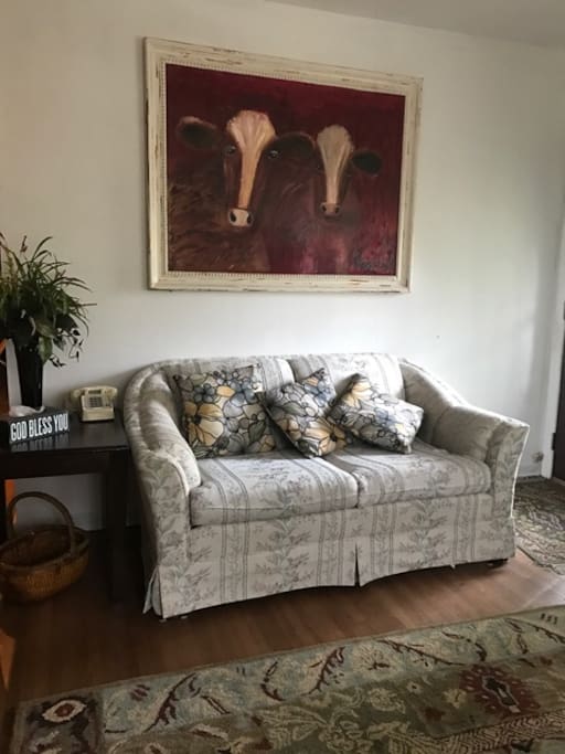 The living room has a pull out double bed and this small couch.