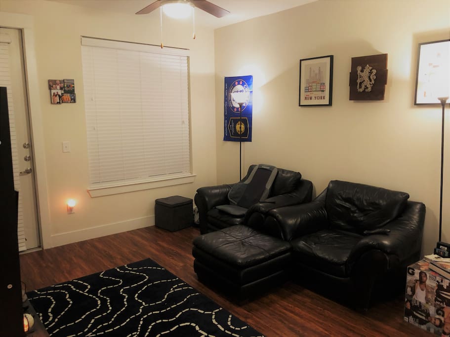 Living Room seating arrangement with ottoman and massage chair.