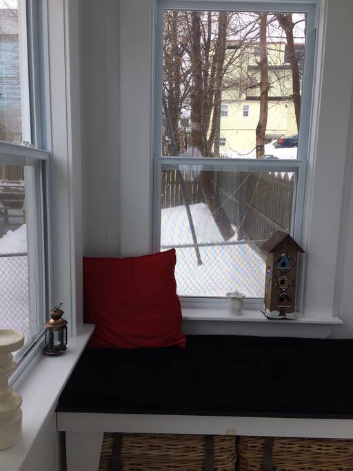 Comfortable window seat faces front lawn well off the street.