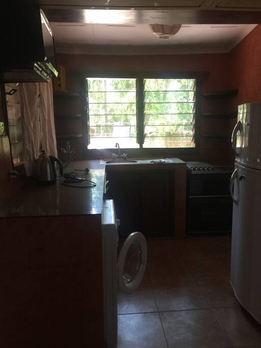 Fully equipped kitchen with cooker, microwave, fridge, washing machine, cutlery and crockery