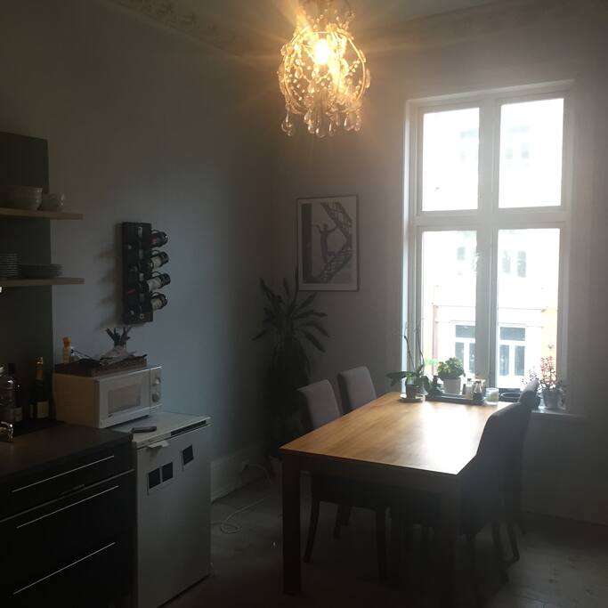 Kitchen table with place for 4-6 people. Micro wave and freezer to the left.
