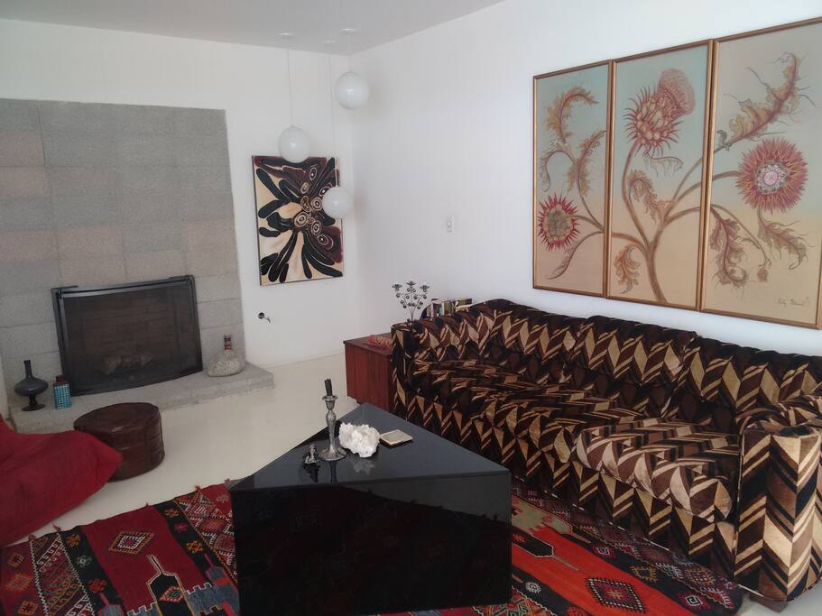 1970esque psychedelic living room with lots of seating for entertaining.