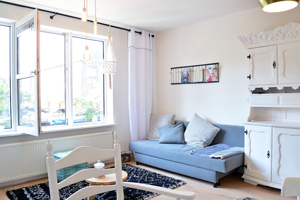 The bright living area has a very comfortable couch. Great to sit back after a day of exploring Amsterdam