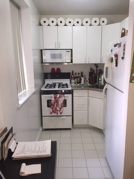 Clean kitchen with gas stove, dishwasher, and window
