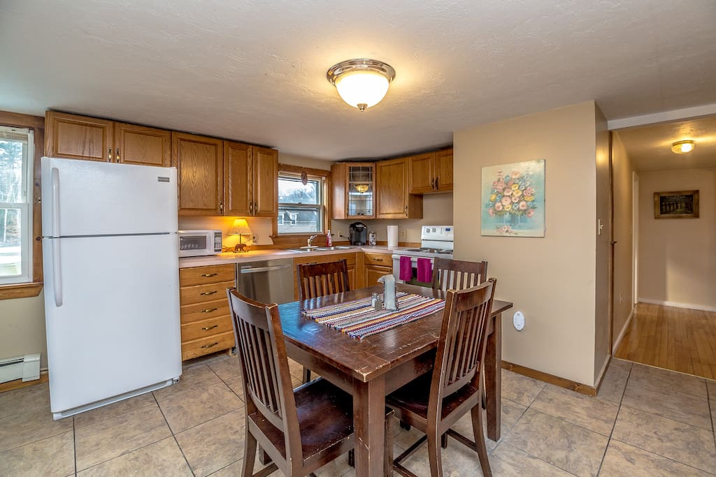 When you walk in the front door of the 2nd floor apartment, you'll be in this great kitchen. It's stocked with anything you could want - waffle/pancake grill, microwave, oven, dishwasher!, Keurig coffee on demand, lobster crackers - and a table which can FIT six (extra chairs on the porch) , and an additional table you could put in the kitchen for even more people to eat together!