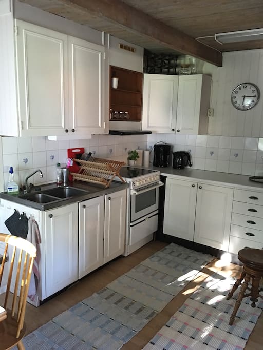 Kitchen with fridge, coffemaker, stove and oven.