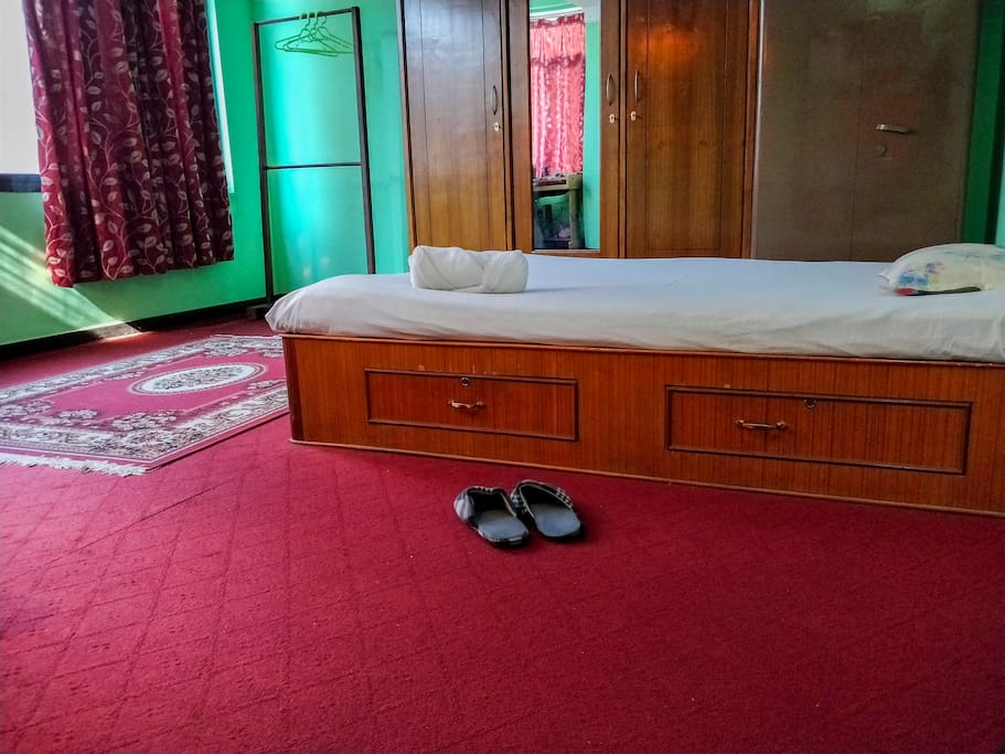 The private guest room has neat bed with big windows and lot of space