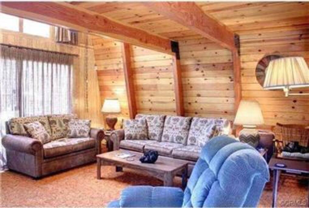 Another pic of the living room that shows the sliding doors out to the front deck! As mentioned the living room comes complete with sofa bed, love seat, recliner, fireplace, Hi Definition Cable TV, DVD/VCR player and Wifi included.