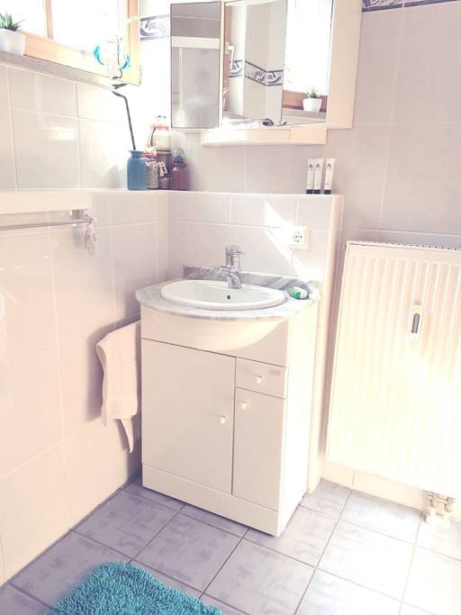 Your bathroom with floor heater, including a sink, a toilet and a shower