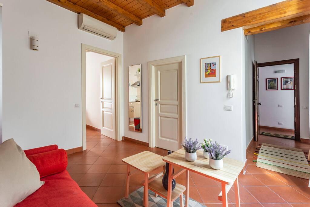 living room - entry door (right), bathroom door and kitchen door (left)