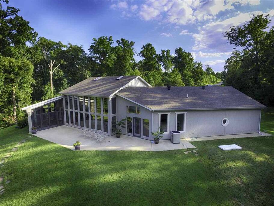 Rear of home showing sunning and dining (screened) patios
