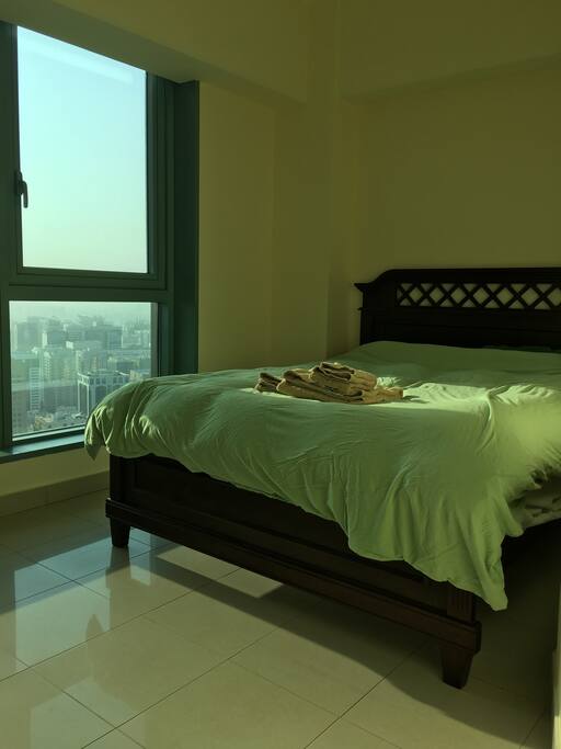 Queen size bed waiting for you with a sunrise view