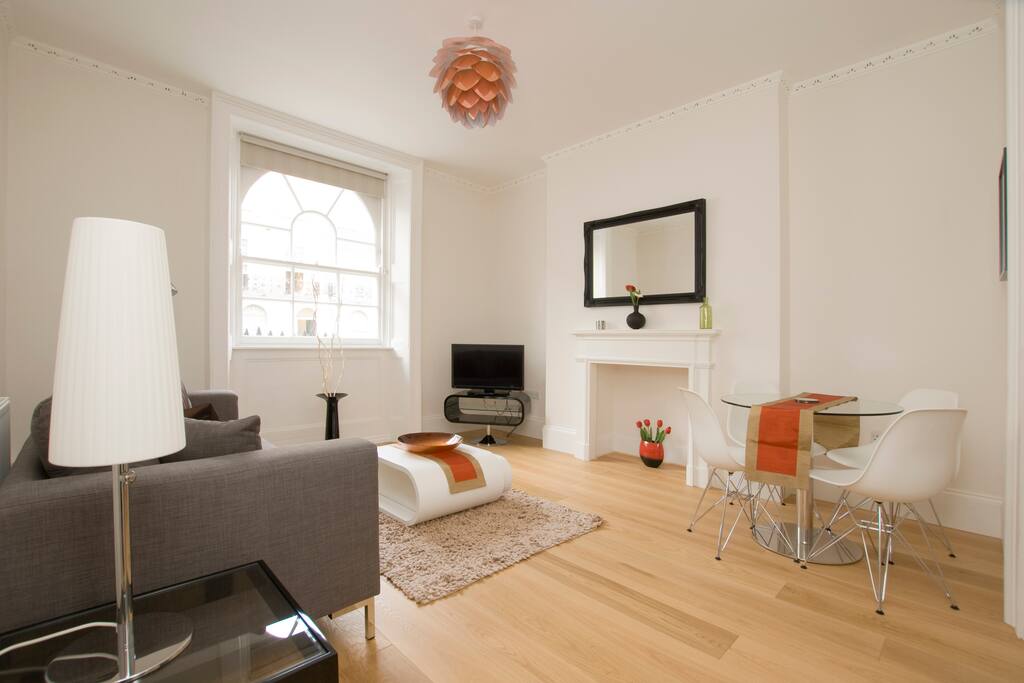 Comfortable Living-room with flat-screen TV and a work/dining table