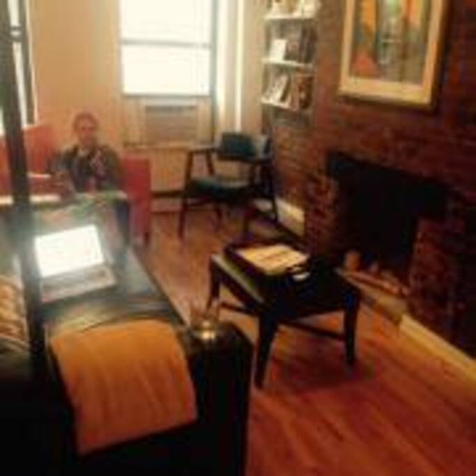 Living area with couch and two comfortable chairs. Nice natural light. TV not depicted.
