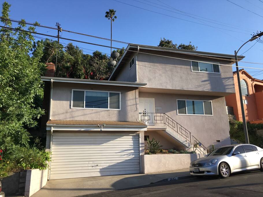 Living and Family Rooms with 1/2 bath above garage and street, with bedrooms and bathrooms upstairs.