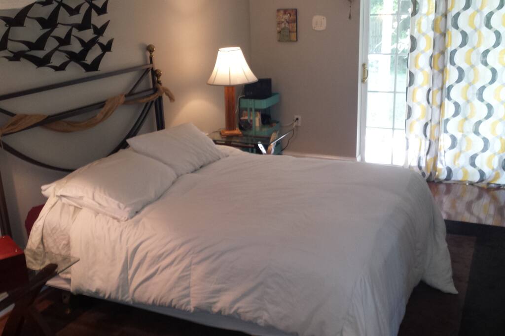 Soft, comfy bed, in room with lots of light and private patio attached.