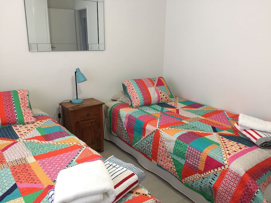 Second bedroom - 2 king single beds, ceiling fan & storage