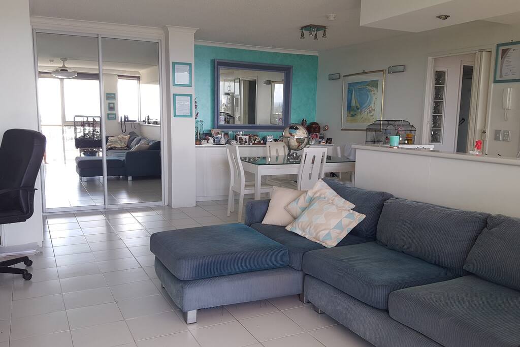 Lounge room with sofa and dining seating for 6.
