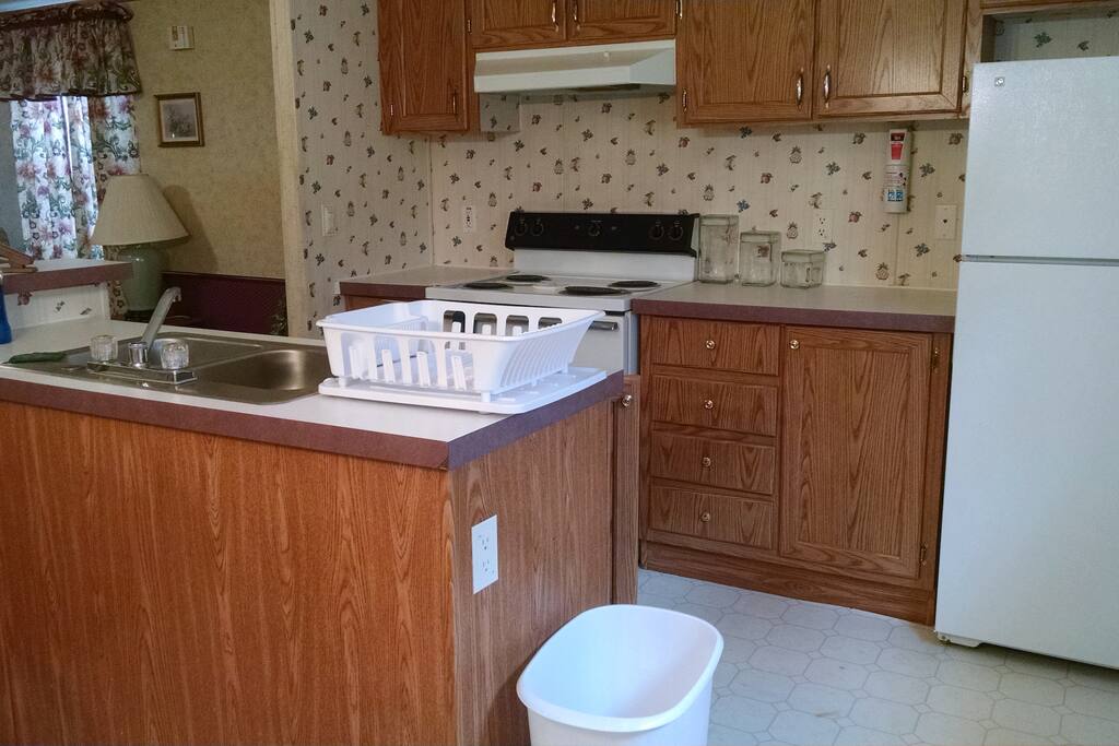 Full kitchen with dinerware, cookware.