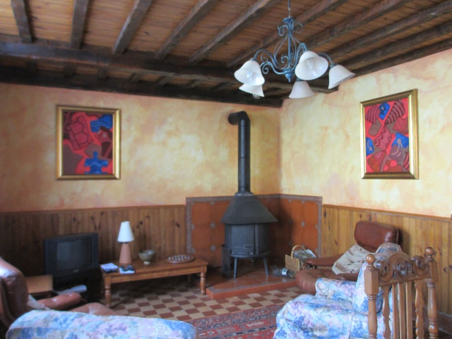 Lounge and dining room, with wood burner stove