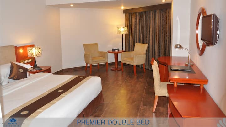 Premier Double Bed

Our Premier Double Bed Rooms are great for couples, families, friends and executives. This is our regular room, set up as an ideal room for all to provide an opportunity for an excellent stay at reasonable price. One gets easily captivated by the furniture, amenities and features of this room. Every room has a balcony to take an outside snapshot. Mini-bar (Non Alcoholic), dual telephone line and free internet cable makes life easy. Feel secure, private and excited with homelike features meeting great standards. Indeed, we hope to provide much more than we say. So don’t miss us on the way!

Room Features & Amenities
Elegantly appointed Deluxe Room incorporating a Bedroom contains a King size Bed or Twin Bed, LCD TV, IDD Telephone, Telephone in the Bath Room, free internet in the room, and also have a work desk, Imported Guest amenities, Hot & cold water, Mini Fridge, Remote controlled A/C. Connecting Rooms are available. The living area contains two chairs & a table. This room is Ideal for Family or Couple.