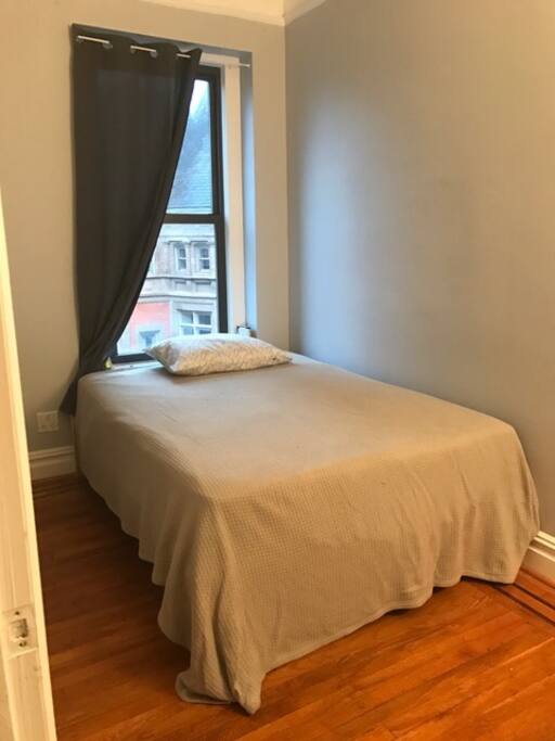 Your room with a full-sized bed and plenty of light