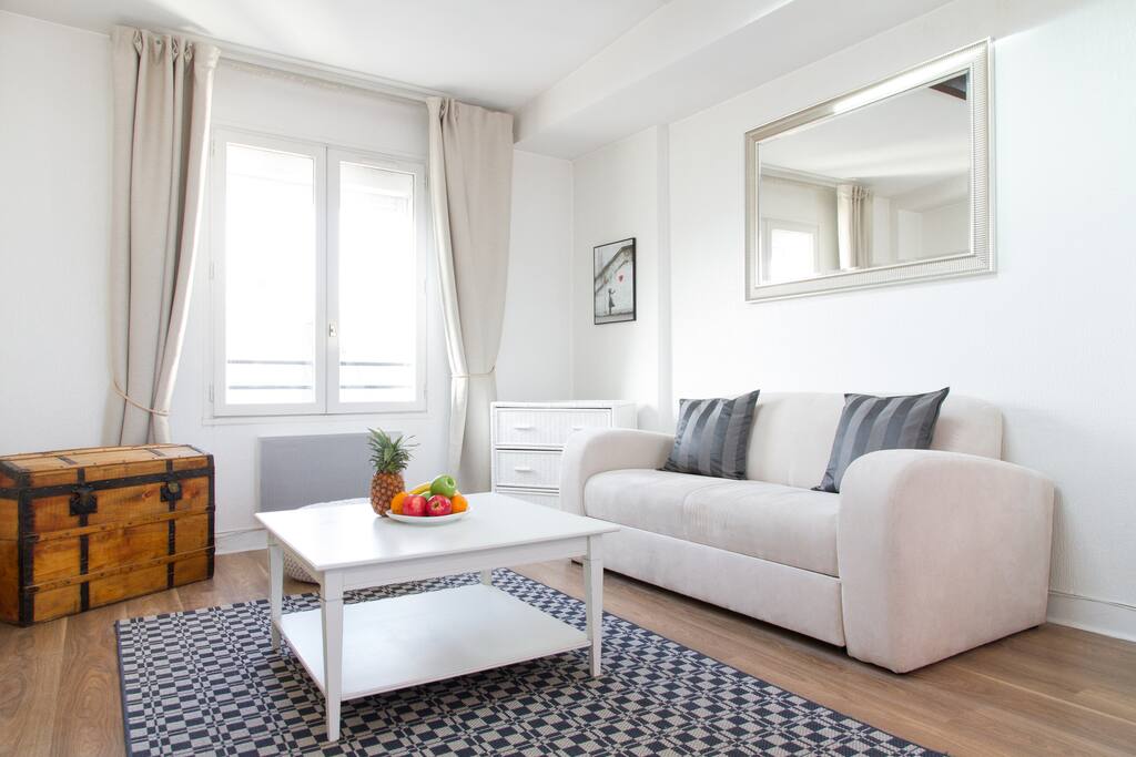 The cosy living room with large windows and chic decor