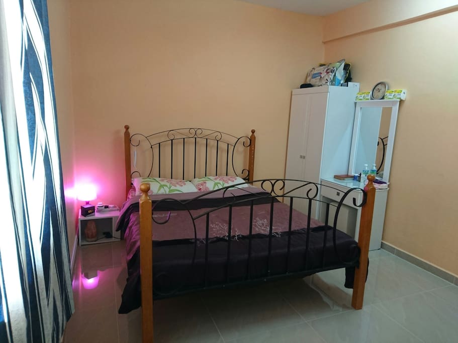 Queen-sized bed with cupboard and dressing table