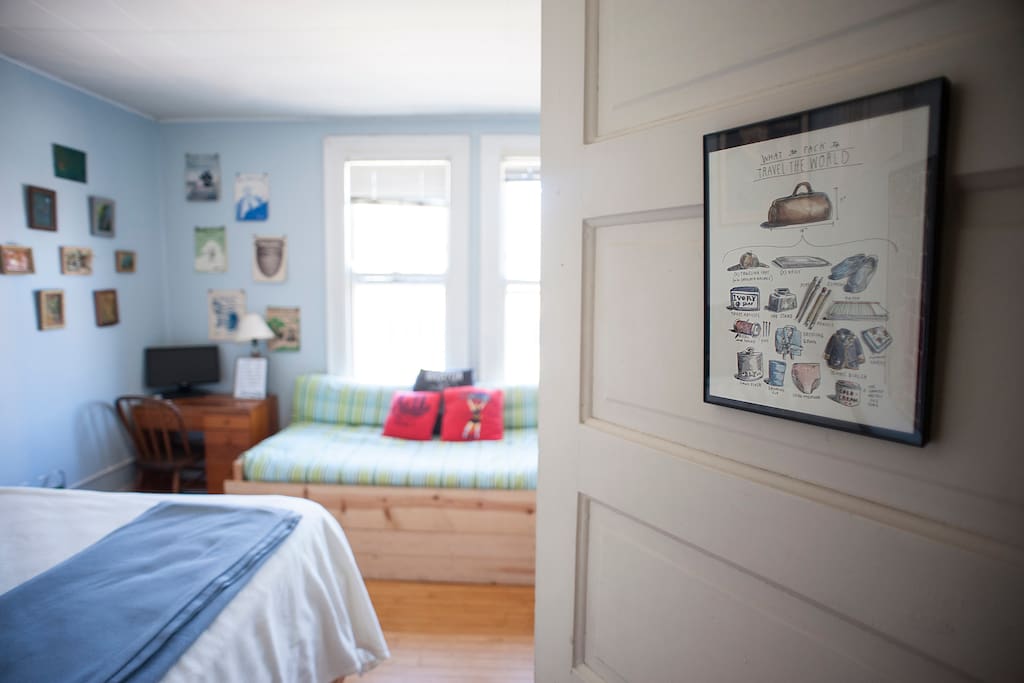 The guest room, which features a lofted queen bed and a couch; for larger parties, the couch folds down to a second queen bed.