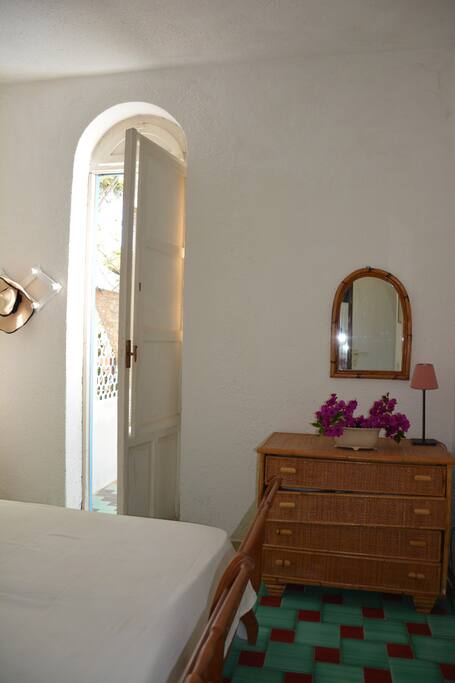 The bedroom with a window-door on the garden.
