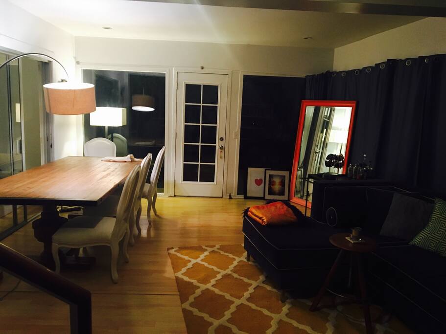 Open Loft style Living space with walls of glass, vintage french dining table and large sectional