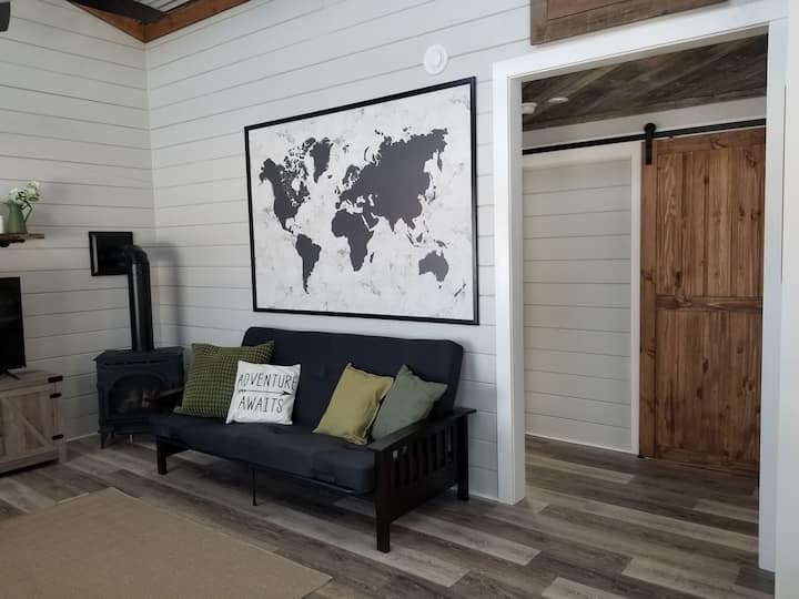 Spacious and cozy living area with tall ceilings and lots of natural light.