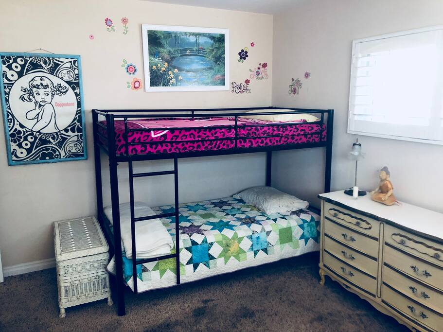 Large kid's bedroom with bunk bed. Could fit an air mattress to accomodate more people. Has large doll house and toys.