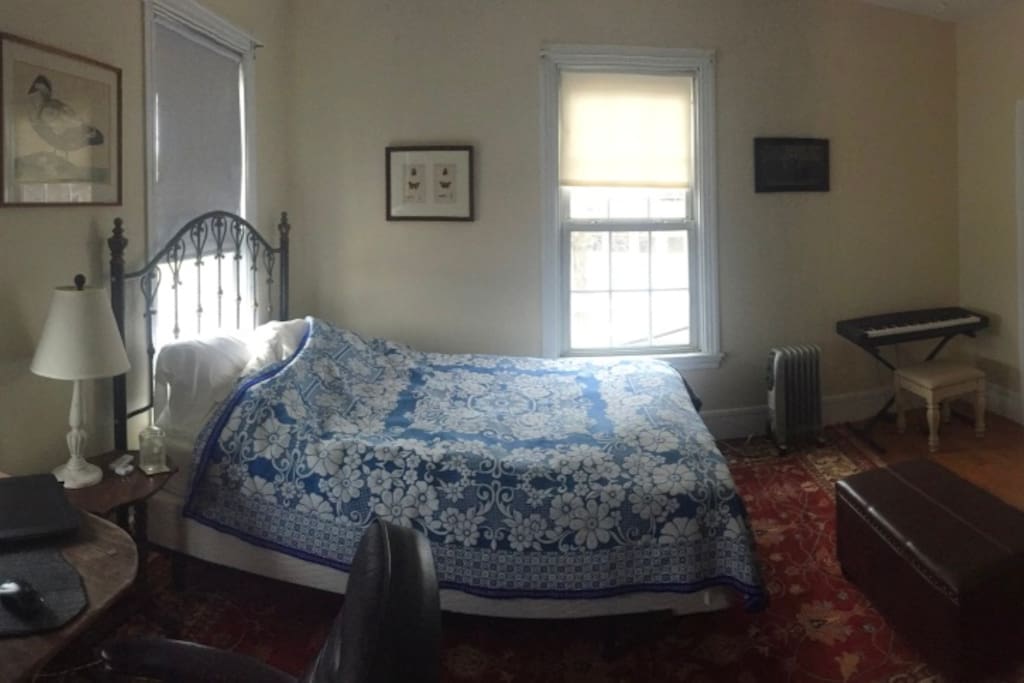 Master bedroom has a workspace, walk in closet, 55" 4K TV, small keyboard piano and two dressers.