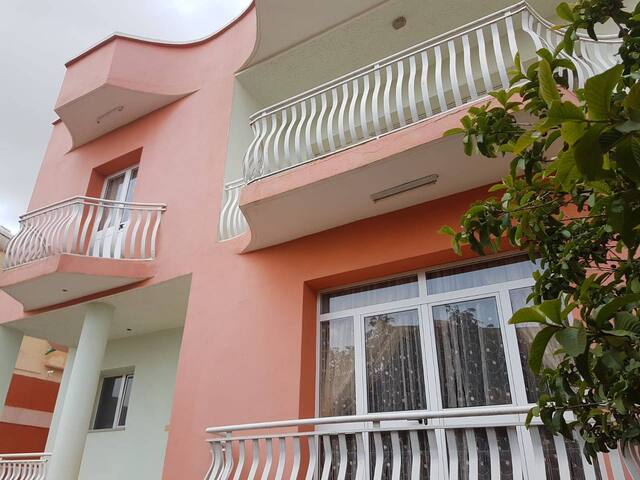 One bedroom in a beautiful salmon-colored house!