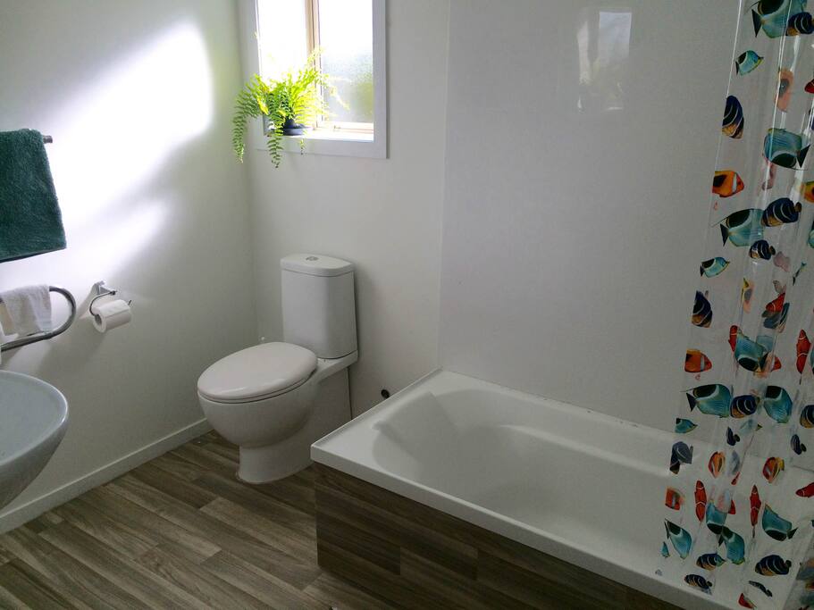 Bathroom with bath and shower, towels included