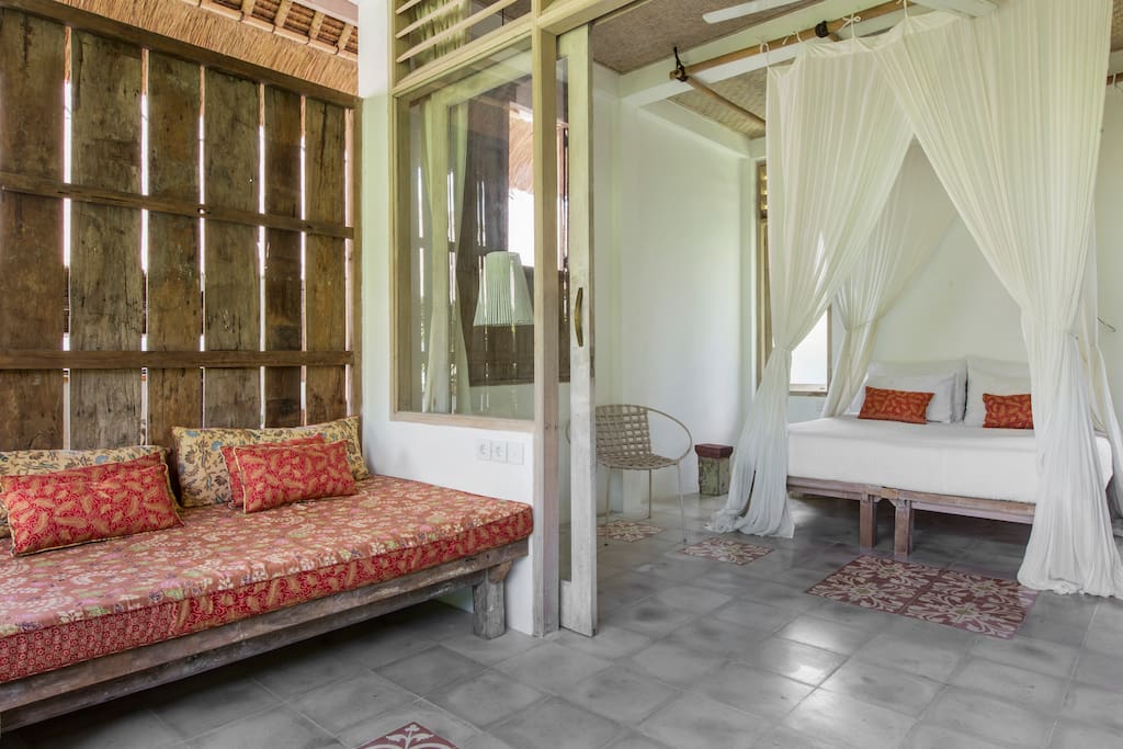 View of daybed and comfy double bed.