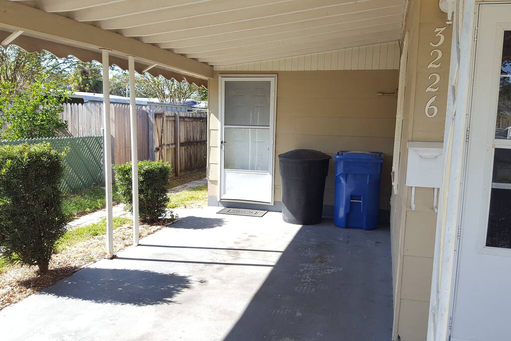 Covered carport with side entry to the fenced in backyard area and private carport entryway into the dining room