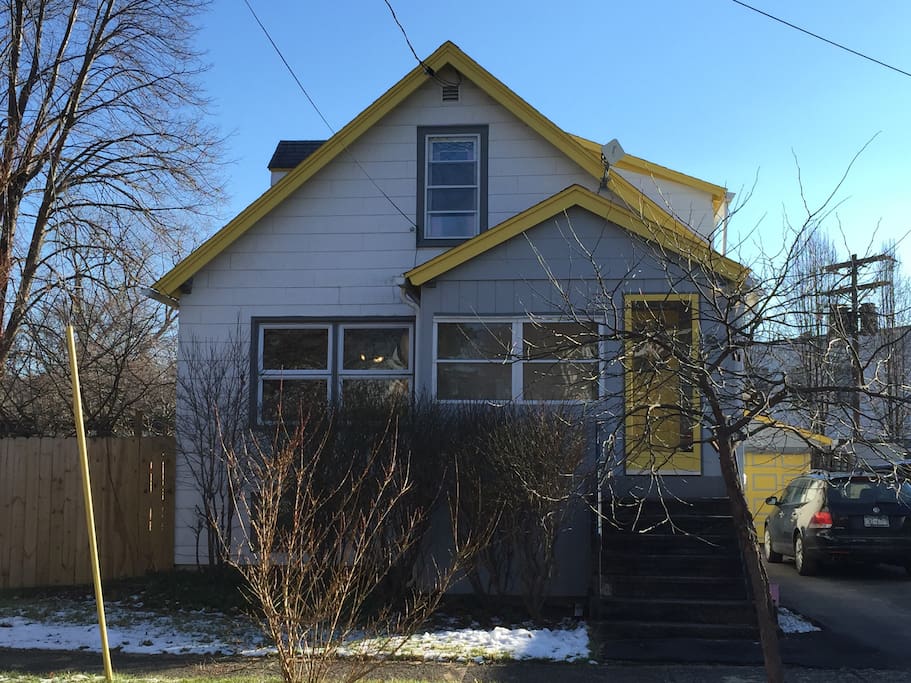 Here's our small house, located on a quiet side street within close walking proximity to the Farmer's Market, waterfront trails, and Stewart Park. Front porch is enclosed and a great place to read and spy on passers-by! Side and back yard are private and fenced in, and the driveway fits three cars, with plenty of nearby street parking.