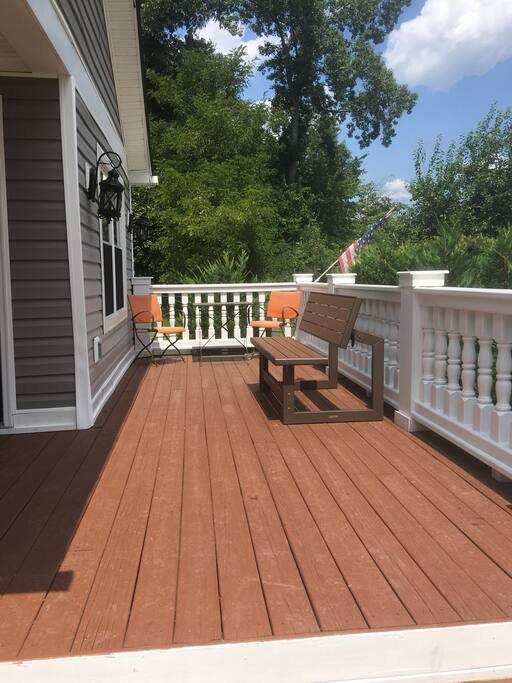 Front porch with bench that turns into picnic table and two person set.