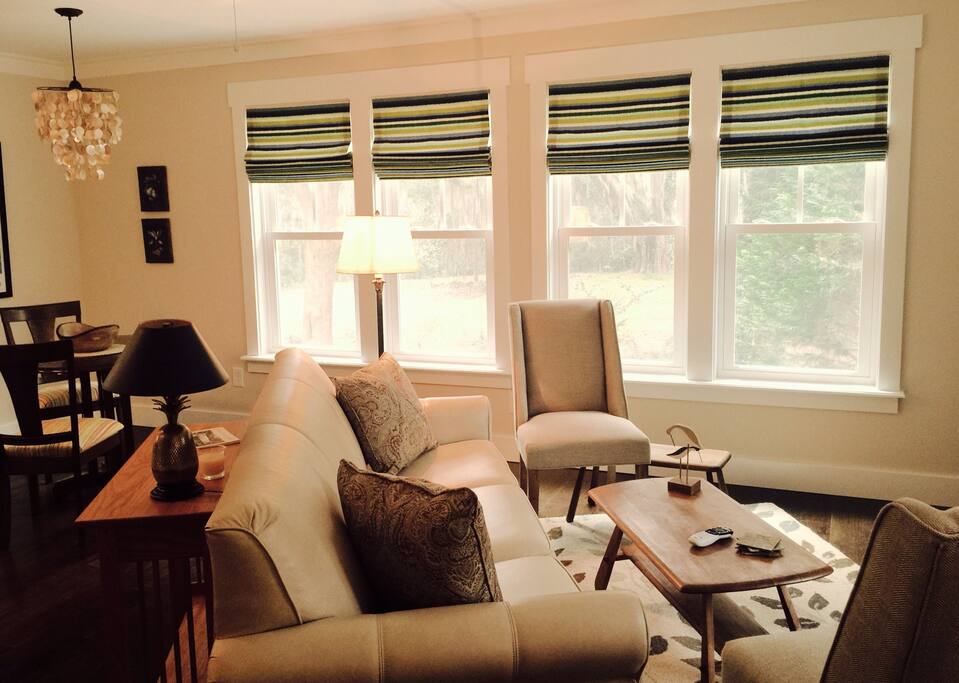 Sitting area, sofa, coffee table, two side chairs and TV.