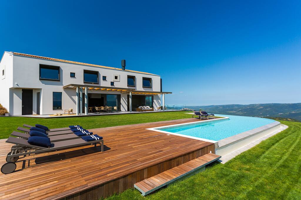 the front of the house and the swimming pool