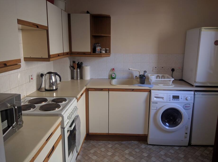 Well appointed kitchen with cooker, microwave, fridge, freezer, kettle, toaster and washer-drier