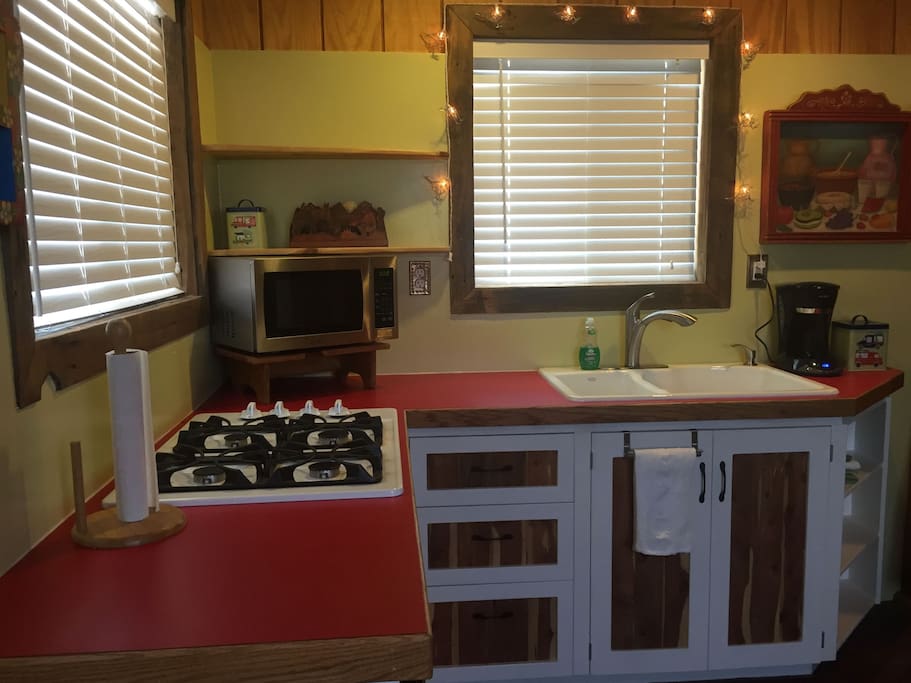 Dormitory sized refrigerator, four burner gas stove top, microwave, coffee maker with a permanent filter, and plenty of dishes, silverware, etc for your vacation needs.
