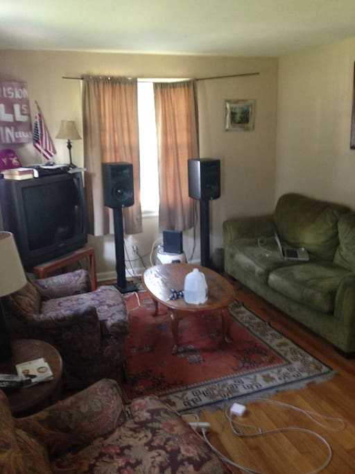 Living room with speakers, cable tv, and wireless internet access. Also, if you need places for extra to people to crash it has a full size couch, and reclining chair.
